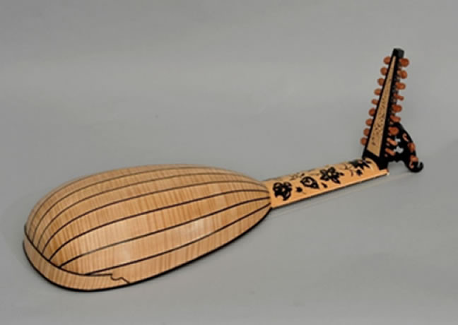 The back of a Baroque lute which is maple with ebony inlaid strips. The flowers are inlaid not painted on.